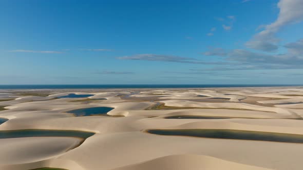 H264drone Going Up And Shows Dunes With Blue Lagoons, In The Background The Sea