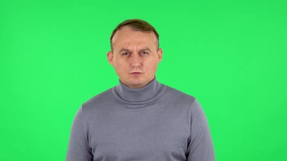 Portrait of Male Looking at Camera with Anticipation, Then Very Upset. Green Screen alt