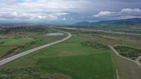 Freeway among green fields alt