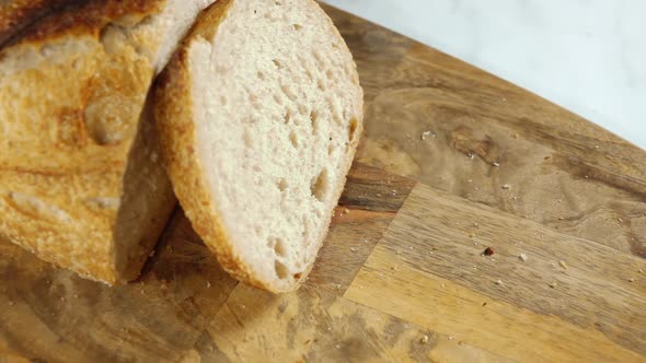 Slicece of Bread Falls on a Cutting Board