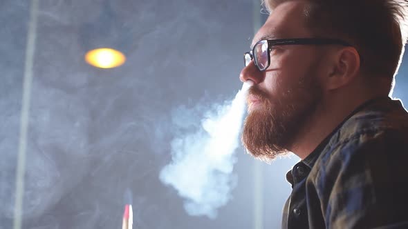 Attractive Man Exhaling Smoke From the Nose. alt