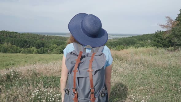 Woman Travels With a Backpack in Beautiful Places