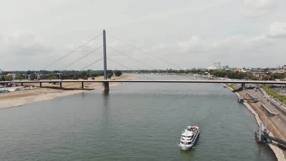 Touristic cruise motorboat on the Rhine river near Oberkasseler Brucke brige , Dusseldorf. alt