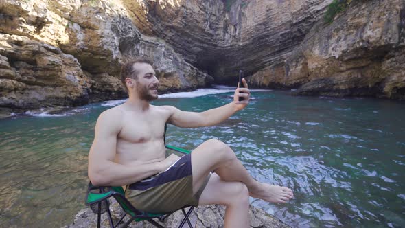 Talking on the phone on the beach. alt