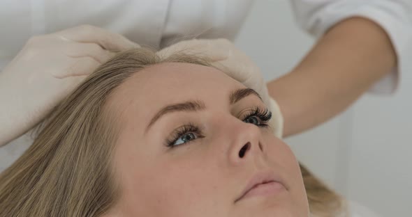 Young Attractive Woman Receives Mesotherapy for Hair. Girl Receives an Injection in the Head alt
