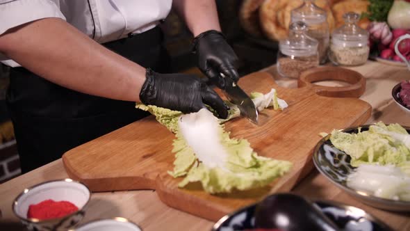 cutting vegetables lettuce, cook hands and knife alt
