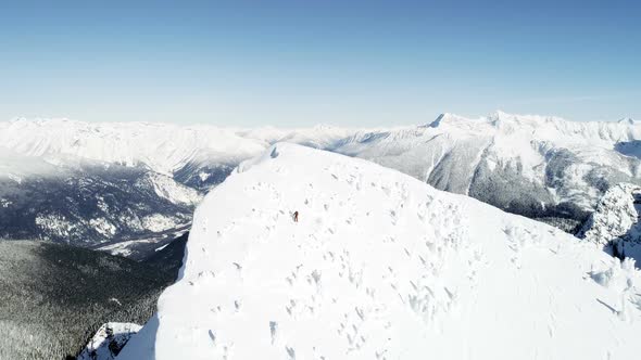 Skier skiing on a snow capped mountain alt