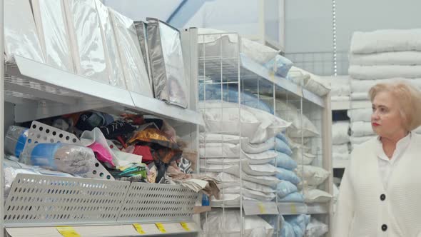 Happy Senior Woman Smiling Joyfully, Walking in Furnishings Store alt