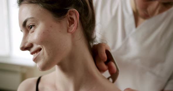 Fascia Release Soft Tissue Treatment on Her Neck with Stainless Steel Tool IASTM alt