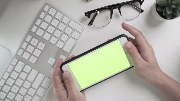 Businesswoman 's hands  working and touch screen the green screen on smartphone