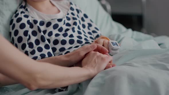 Mother Holding Daughter Hands Waiting for Medication Treatment After Sickness Infection alt
