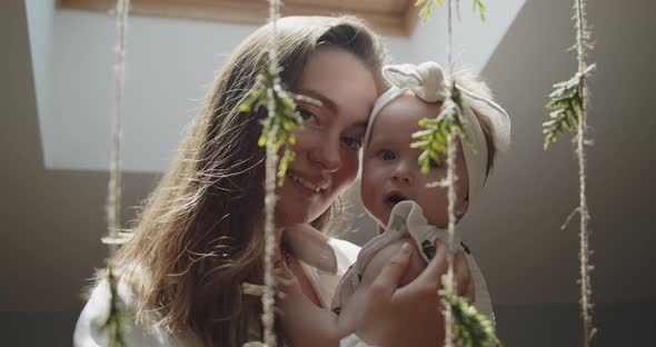 Closeup Portrait of Young Mother Holding Her Cute Little Baby Daughter
