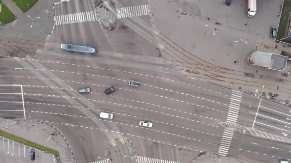 Tram and Cars Moves Through a Large Intersection - Drone Overhead Zoom-in Shot alt