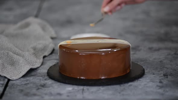 CloseUp Pastry Chef'S Hands Is Decorating The Mousse Cake With Peanuts