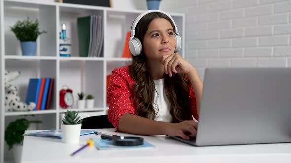 Cheerful Teen Girl in Headset Typing Online on Computer Education alt