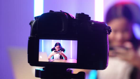 Display Camera Of Excited Asian Kid Girl Playing Video Game With Mobile Phone While Live Stream alt