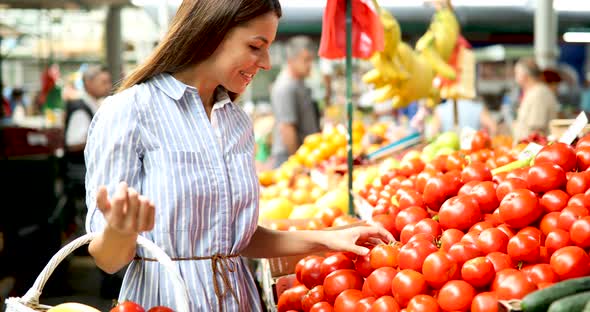 Picture of Woman at Marketplace Buying Vegetables alt
