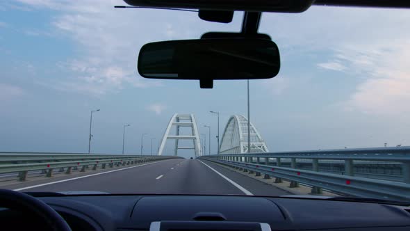 Car is Driving Over Bridge alt