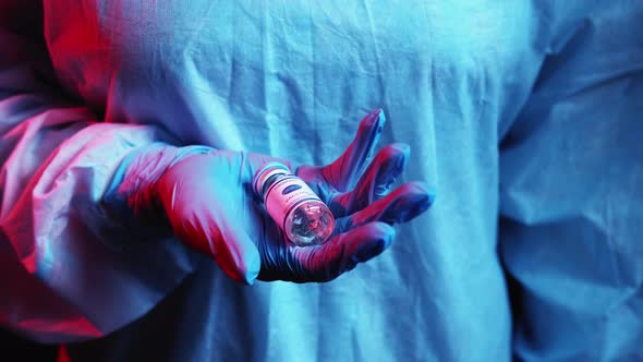 Covid19 Vaccine Dose Vial in Doctor Hand in Glove alt