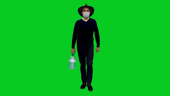 Confident Adult Male in Protective Mask Carries a Canister of Fresh Water