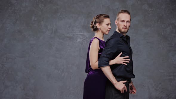 Professional Tango Dancers Stand in Starting Position in a Grey Studio alt