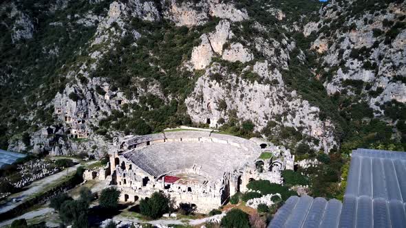 High angle drone aerial view of ancient greek rock cut lykian empire amphitheatre and tombs in Myra alt