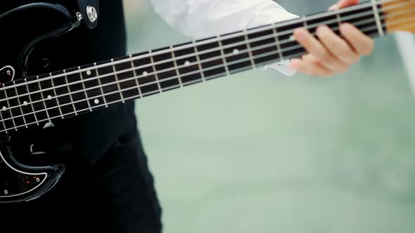 Musician Playing Electric Guitar. Closeup on Hands Playing on Electric Guitar alt
