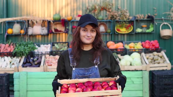 Woman Farmer (Seller) With Apples at the Farmer's Market. alt