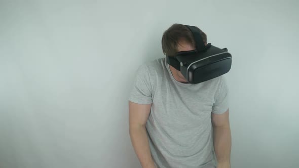 Man Uses A Virtual Reality Helmet In A Fighting Game Simulation Using The Style Of A Drunken Ninja