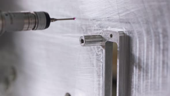 Macro footage of a coordinate measuring machine CMM measuring metal part