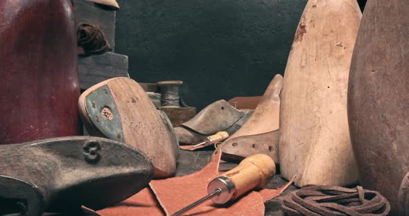 Cobbler workshop with tools, leather and strap. Vintage shoemaker workshop. alt