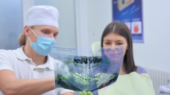 Dentist Show Panoramic Mouth Xray Image To Patient