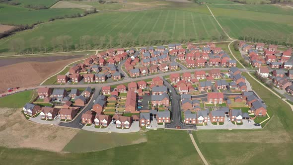Aerial view of a residential estate in England with red brick houses and gree