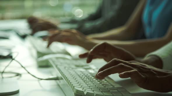 College students typing exam alt