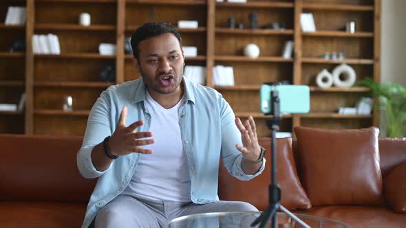 Young Indian Male Blogger in Casual Clothes Streaming Video Online alt