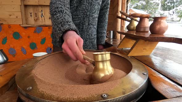 Preparing Turkish Coffee in a Copper Cezve on Hot Sand is an Old Turkish Way of Brewing a Coffee