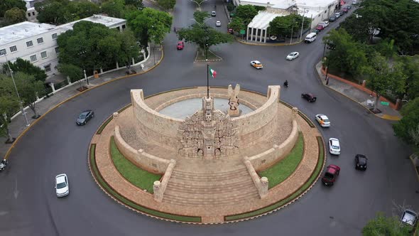 Aerial pull back from the Monument a la Patria, Homeland Monument on the Paseo de Montejo in Merida, alt