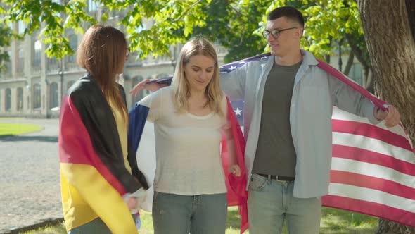 Group of International Students Hugging and Smiling on University Campus Yard. Positive Men and alt