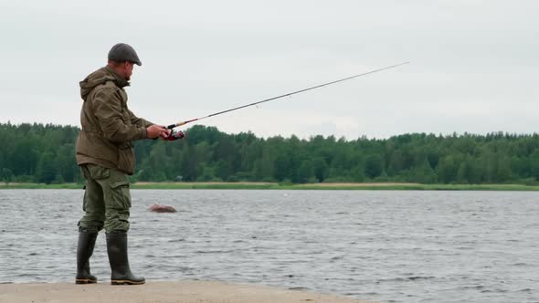 Fisherman On A Lake Pier