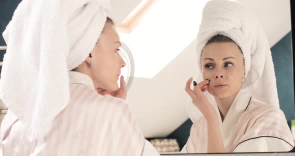 Attractive Woman Applying Cream on Skin Under Eyes at Home