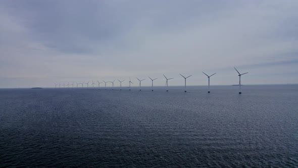 Calm Sea Waters and Windmills Rotating in Unison alt