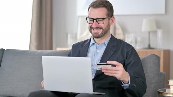 Successful Online Payment on Laptop By Young Man alt