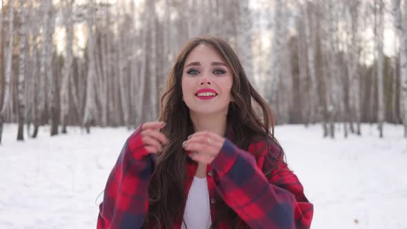 Charming Female with Long Hair Walking in Snowy Forest