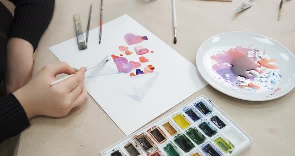 Process of Painting Card with Hearts for Valentine's Day Closeup