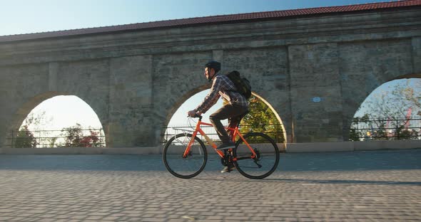 Authentic Creative Shot of a Man Cycling Bicycle at Sunrise