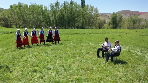 Young Women Traditionally Dancing In Traditional Clothes And Musicians In Village alt