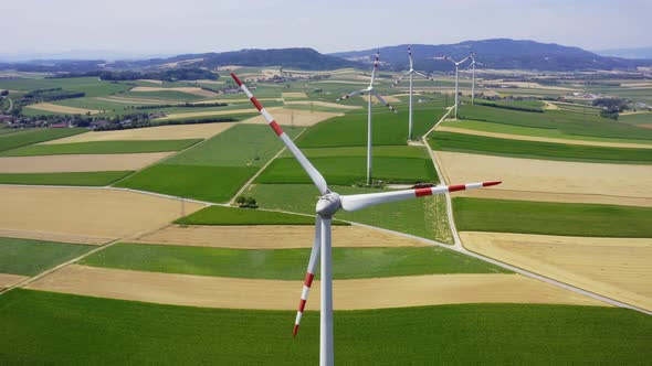 Aerial flight wind turbines. Renewable Clear Energy production. Farm landscape. Drone footage Europe