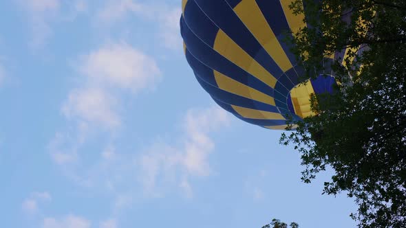 Bottom View of Beautiful Hot Air Balloon Flying Over the Trees, Leisure Activity alt