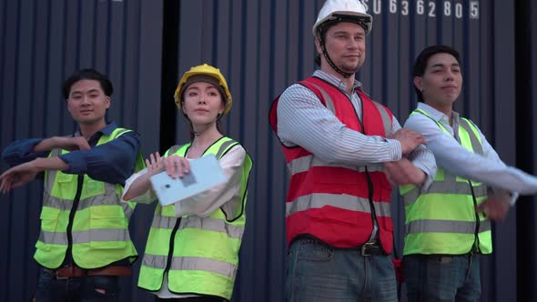 Factory worker and engineer team smiling with arms crossed in a shipyard