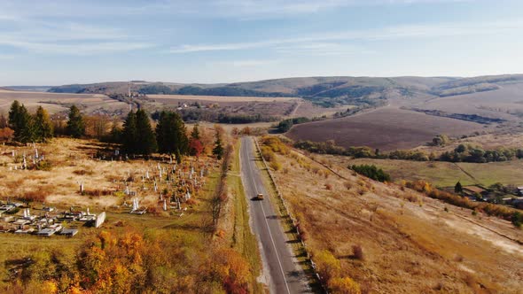 Aerial View of Autumn Road Car. Skyl View Country Road in Autumn. Forest and Highway Road Drone View